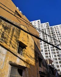 Low angle view of buildings against blue sky