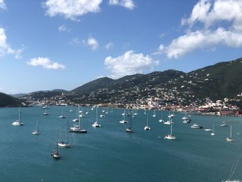 Sailboats in sea against sky