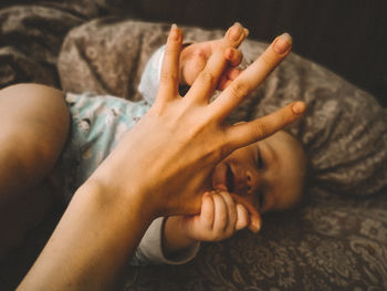 High angle view of woman lying on bed