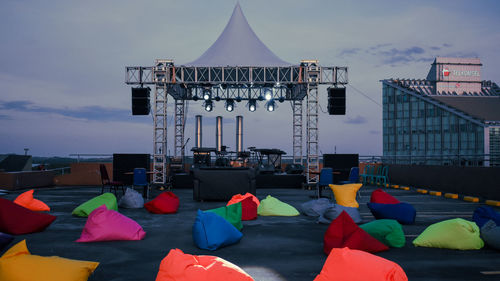 People on multi colored umbrellas against sky in city