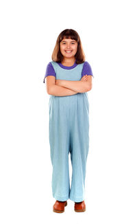 Portrait of smiling girl standing against white background