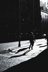 Shadow of woman on city street
