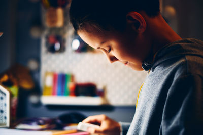 Portrait of boy looking at camera at home