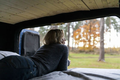 Rear view of woman sitting in bus