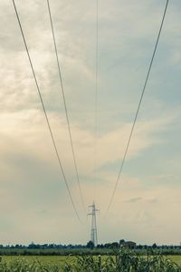 Low angle view of electricity pylon against sky