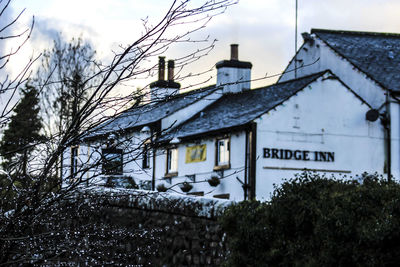 Low angle view of house against sky during winter