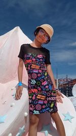 Portrait of young woman standing at beach