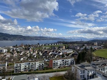 High angle view of townscape by sea against sky