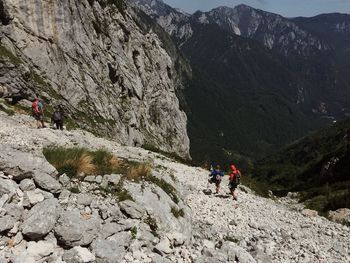 People on mountain against sky