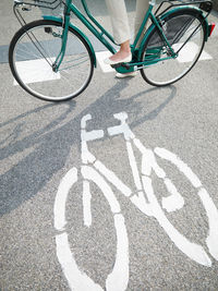 Shadow of man riding bicycle on road