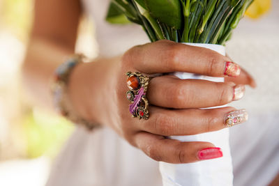 Midsection of bride holding colorful bouquet