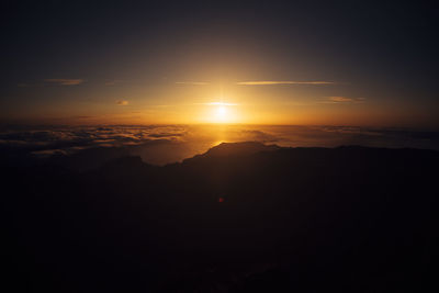 Scenic view of silhouette mountain against sky during sunset