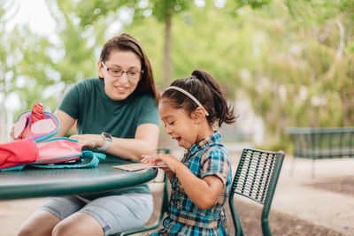 Young millennial mother sending daughter off back to school