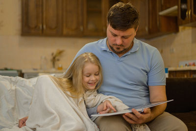 Side view of young woman working at home