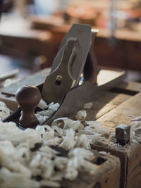 Close-up of a carpenter bench with tools and wood shavings and chips