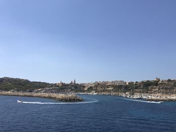 Scenic view of sea against clear blue sky