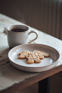 High angle view of cup of tea and biscuits on table