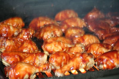 High angle view of grilled chicken legs on barbecue grill