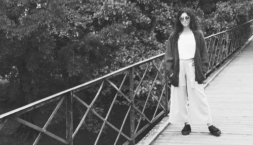 Woman standing on footbridge