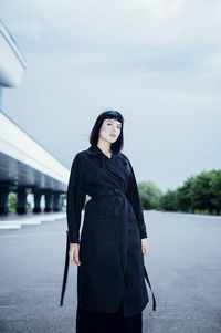 Fashionable portrait of a woman in a black cloak