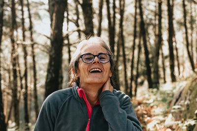 Young woman looking away in forest