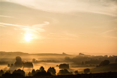 Misty countryside landscape against the sky