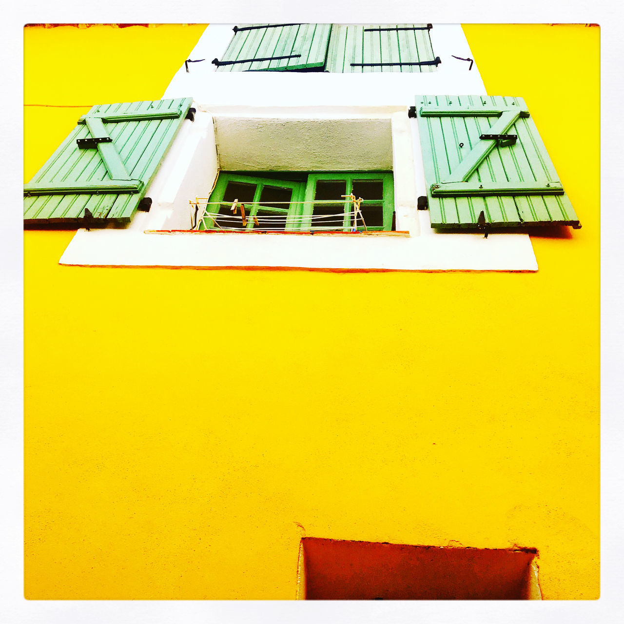 LOW ANGLE VIEW OF YELLOW BUILDING AGAINST SKY