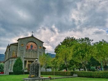 Facade of church against cloudy sky