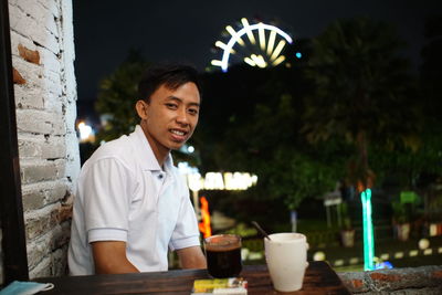 Portrait of young man holding food