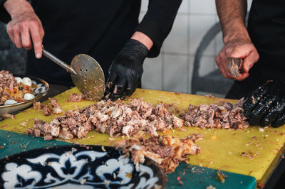 Midsection of man preparing food