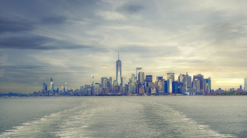 Panoramic view of buildings against cloudy sky