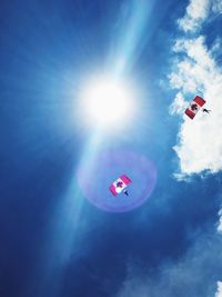 Low angle view of parachute against blue sky