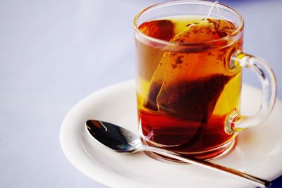 Close-up of teabag in cup on saucer