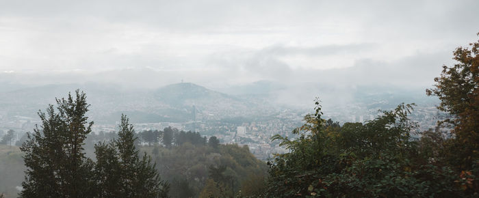 Panoramic view of trees and mountains against sky