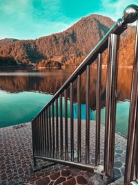 Scenic view of lake by mountains against sky