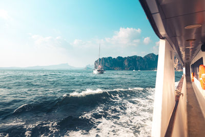 Sailboat sailing on sea against sky