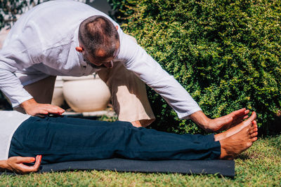 Hands of a reiki therapist healing and balancing energy points in feet. energy healing concept