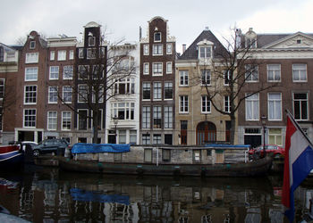 Boats in canal with buildings in background