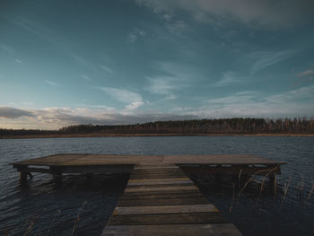 Pier over lake against sky