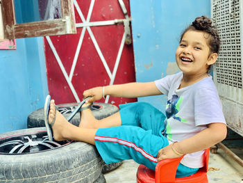 Portrait of smiling boy sitting outdoors