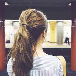 Rear view of woman at railroad station