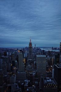 Skyscrapers against cloudy sky