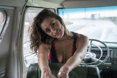 Teenage girl portrait in front seat of vintage van