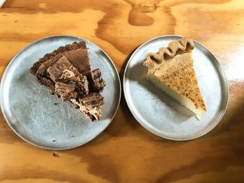 High angle view of cake served in plates on table