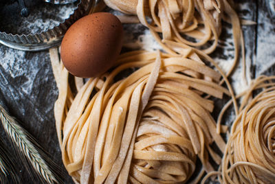 Close-up of pasta with egg on table