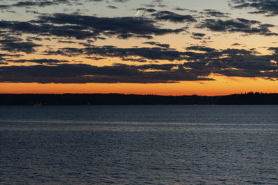 Scenic view of sea against orange sky