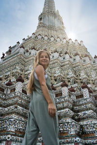 Low angle view of woman standing against building