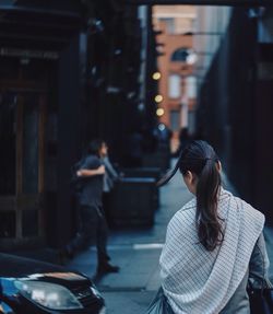 Rear view of woman on footpath