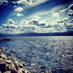 Scenic view of sea against cloudy sky