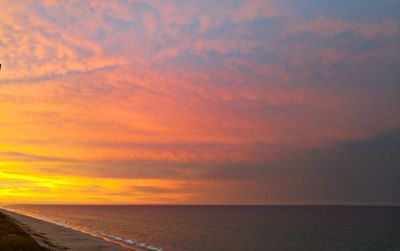 Scenic view of beach against sky during sunset